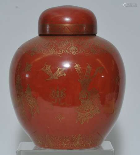 Porcelain covered jar. China. Late 19th to early 20th century. Oviform. Orange glaze with a gilt decoration of The Hundred Antiques and various auspicious symbols. 11