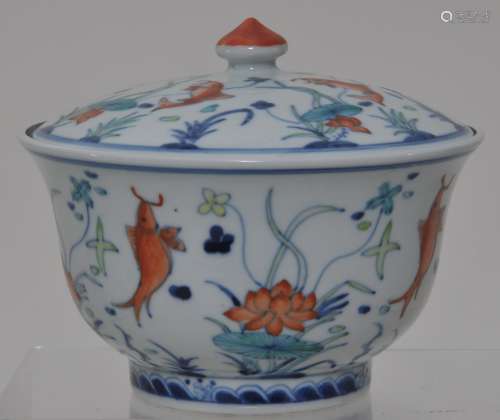 Porcelain covered bowl. China. 19th century. Tou tsai ware, Decoration of fish and lotus plants. Ming Jia Jing mark. 5-1/2
