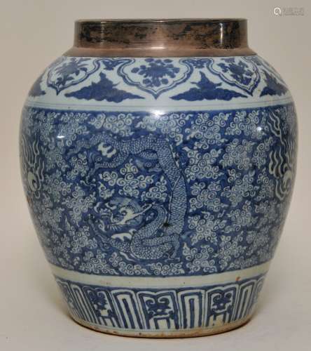 Porcelain wine jar. China. Ming period (1368-1648). Kuan with underglaze blue decoration of dragons, pearls and clouds. Silver mounted rim. 14