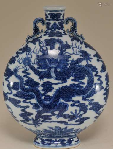 Porcelain vase. China. 20th century. Moon flask form. Underglaze blue decoration of dragons and clouds.  11-3/4