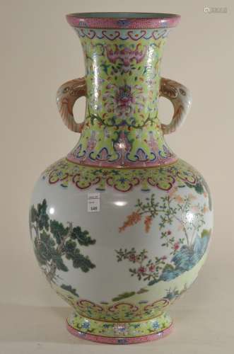 Porcelain vase. China. Ch'ia Ch'ing mark (1795-1820) and probably of the period. San Yang design of three sheep in a garden. Chartreuse borders with stylized lotus scrolls. Elephant handles. 13-1/2