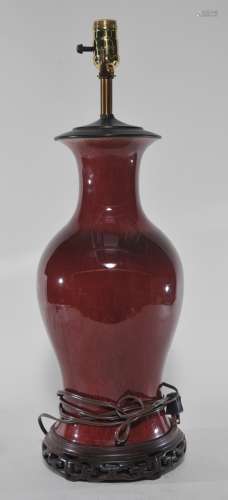 Porcelain vase. China. 19th century. Baluster form. Oxblood glaze. Drilled for a lamp. Wooden base and metal top. 15-1/2