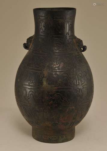 Bronze vase. China. 19th century. Hu form with elephant handles. Huai style intaglio decoration of figures and animals.  11-1/4