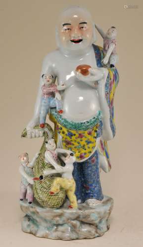 Porcelain figure. China. Early 20th century. Standing figure of Milofu with his bag of wealth and children. Famille Rose palette. 11