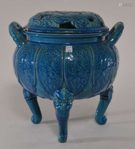 Stoneware censer. Japan. 19th century. Animal form tripod base. Decoration of floral scrolling beneath a turquoise glaze. Pierced lid decorated with a dragon and cloud motif. Chips to the cover. 9-1/2
