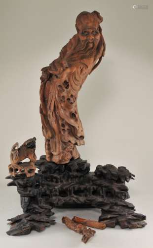 Rootwood carving. China. 18th/19th century. Boxwood figure of Saho Lao on hardwood base. Damage to the staff, cracks. 18-1/2