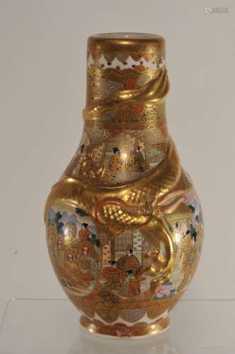 Pottery vase. Japan. Meiji period. (1868-1912). Satsuma ware. Pear shaped with a dragon about the body. Decoration of Buddhist saints, women and warriors. Signed. Stains on the inside of the mouth. 7-1/2
