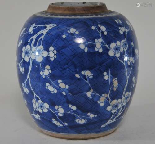 Porcelain jar. China. 18th century. Underglaze blue decoration of flowering prunus on an ice ground. Chips to the mouth rim. 9-1/2