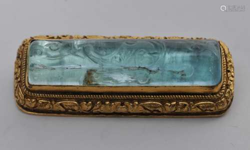 Brooch. China. 19th century. Central stone a bar carved beryl. Chased gilt metal mounts. 2-1/2