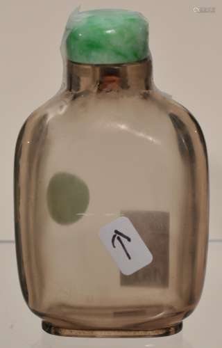 Smoky quartz snuff bottle. China. 19th century. Very well hollowed. Jadeite stopper. Line to the body barely visible. 2-1/2