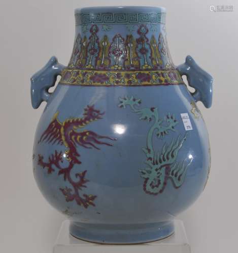 Porcelain vase. China. 19th century. Hu form with animal mask handles. Grey blue glaze with enameled stylized dragons. Acanthus panel around the neck. 10-1/2