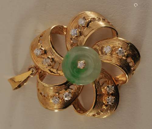 18 karat gold pin. Wheel pendant inset with diamonds and a green jade disk.