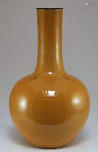 Porcelain vase. China. 19th century. Bottle form. Mustard coloured glaze with a manganese mouth. 15-1/4