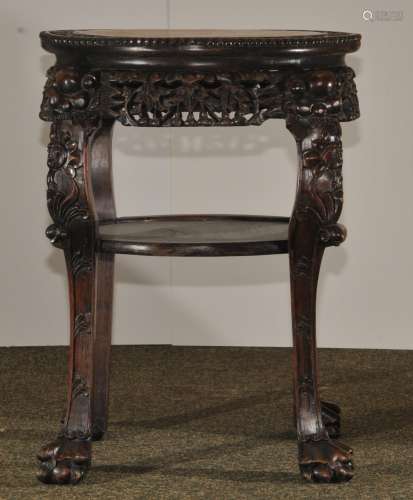 Tabouret. China. 19th century. Round form with two tiers. Rosewood carved with animal heads and feet. Aprons carved with gourd plants. 20
