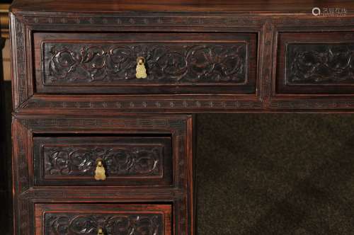 Pedestal desk. China. 19th century. Rosewood. Seven drawers. Surface carved with lotus scrolling. 50-1/2