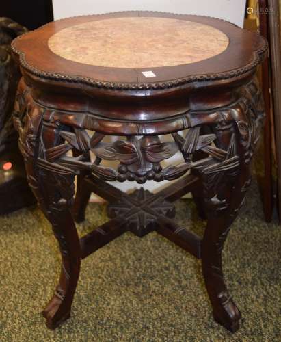 Occasional table. China. 19th century. Rosewood foliated top inset with a marble top. Aprons carved with bamboo.  16