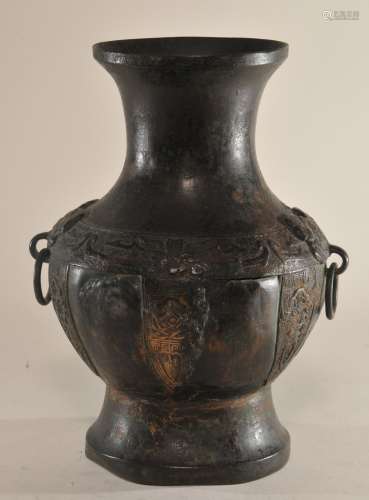 Bronze vase. China. 19th century. Archaic Hu shape. Decoration of Tao Tieh masks. Damage to one side. 10