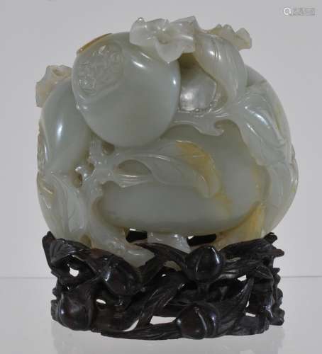 Jade carving. China. 18th/19th century. Celadon coloured stone with russet markings. Study of three pomegranates. 3-1/2