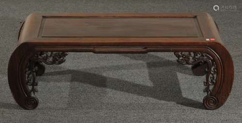 Kang table. China. 19th century. Rosewood. Apron of carved dragons. 37