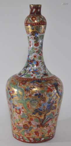 Porcelain vase. China. 19th century. Underglaze blue floral decoration. Surface clobbered in green and red enamels with gilt. 15
