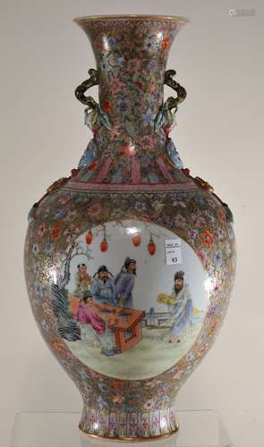 Porcelain vase. China. Republic period. Circa 1920. Globular body with a slightly flaring neck, moulded decoration of a branch of peaches, shou medallions, and tasselled cash coins. Fan Tsai reserves of scholars, women, and children, all on a gilt ground with famille rose (100 flowers). Chien Lung mark on base. 13.5