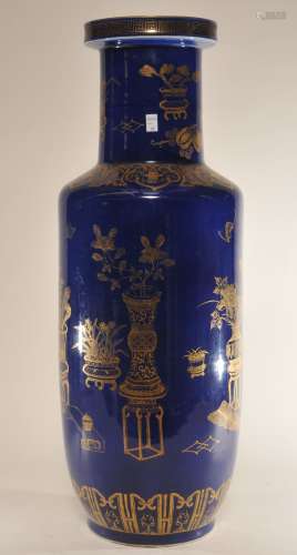 Porcelain vase. China. 19th century. Roleau form. Cobalt blue glaze with gilt decoration of The Hundred Antiques. 23-3/4