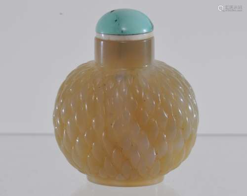 Jade Snuff bottle. China. 19th century. Well hollowed. Surface carved with a basket weave surface. Turquoise top. 1-3/4