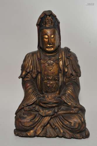 Carved wood figure of The Goddess of Mercy- Kuan Yin. China. 19th century. Seated figure with a surface of red and black lacquer with gilt. 20