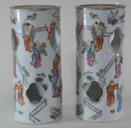 Pair of porcelain hat stands. China. 19th century. Cylindrical from with quatrefoil piercings. Famille Rose decoration of The Immortals. 10-3/4