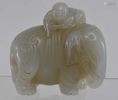 Jade carving. China. 19th century. Greenish white stone. Carved as a child on the back of an elephant. 3