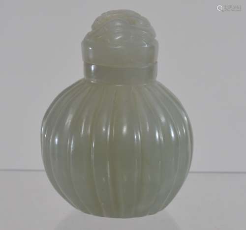 Jade Snuff bottle. China. 20th century. Stone of a pale celadon colour. Ribbed body. Chih lung stopper. 1-3/4