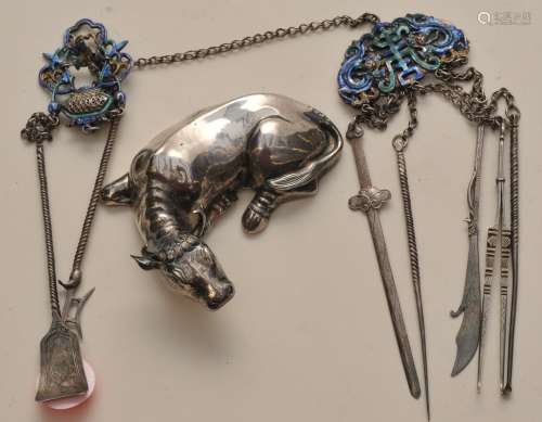 Lot of two silver works. China. 19th century. To include an enameled silver chatelaine and a reclining cow.