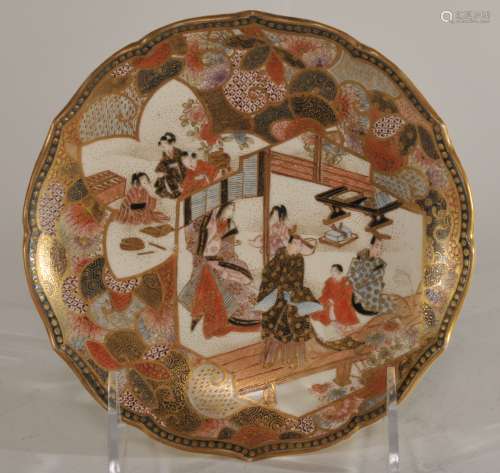 Pottery plate. Japan. Meiji period. (1868-1912). Satsuma ware. Scene of courtiers and brocade patterns. Foliate edge. Signed Kozan. 6