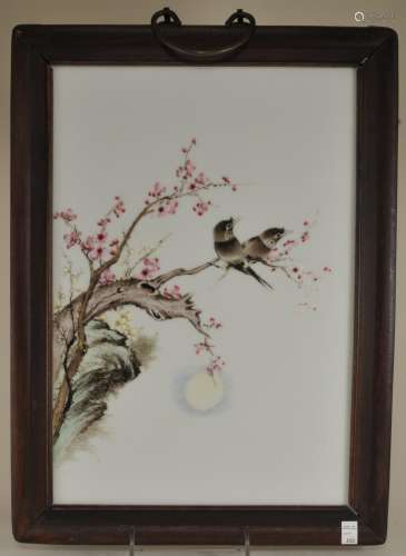 Porcelain plaque. China. Early 20th century. Decoration of two birds in a flowering tree. Faded inscription to the lower right. 16-1/2