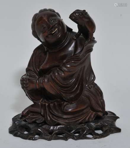 Rosewood carving. China. Early 20th century. Figure of Liu Ha with his frog. Fitted stand. 8-1/2