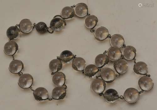 Set of Rock Crystal beads. Japan. Meiji period. (1868-1912). Chased silver mounts with a design of flowers.
