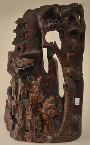 Wood carving. China. 19th century. Mountain grotto with a scholar and attendant. Surfaces of red, black and gold lacquer. Cracks and minor loss. 14-1/4