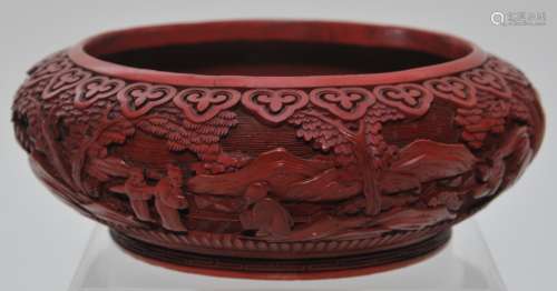 Cinnebar bowl. China. 19th century. Carved with figures in a landscape. Ju-i border. 6-3/4