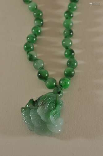 Set of Jade beads with a cabbage pendant.
