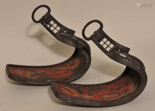 Pair of stirrups. Japan. 18th century. Abumic of iron inlaid with silver heraldic crests and floral motifs. 11