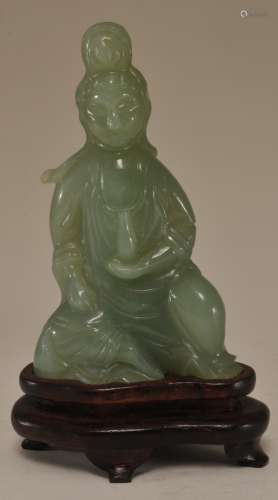 Hardstone carving. China. 20th century. Highly translucent bright Celadon colour. Seated figure of the Goddess of Mercy.  4-3/4