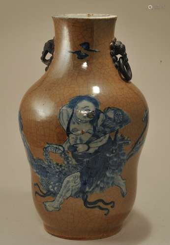 Porcelain vase. China. 19th century. Underglaze blue decoration of Liu Hai on a crackled Cafe au Lait ground. Foo dog masks jump rings. Truncated, one jump ring missing. 14-1/4