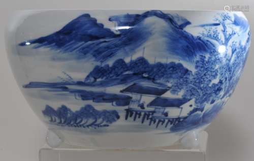 Porcelain fish bowl. China. 19th century. Globular f form with a tripod base. Underglaze blue decoration of a landscape. 11