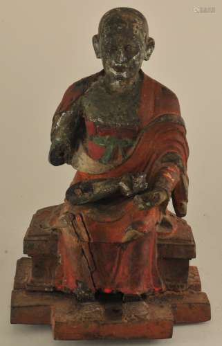 Wood carving. China. Ming period (1368-1644). Hardwood seated monk. Lacquered surface. Loss and old repairs. 8-1/2