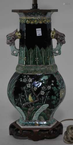 Stoneware vase. China. 19th century. Hexagonal baluster form with phoenix handles. Famille Noir relief decoration of birds and flowers. 12