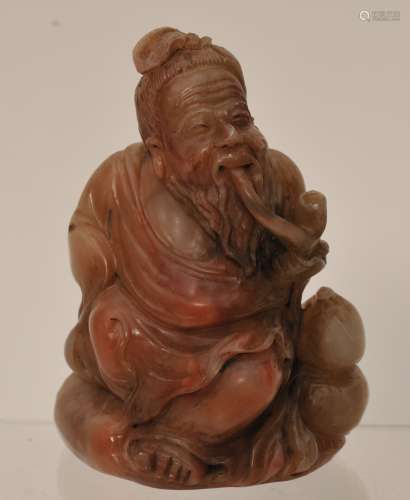 Soapstone seal. China. 20th century. Seated immortal smoking a pipe. Impression intact. 3