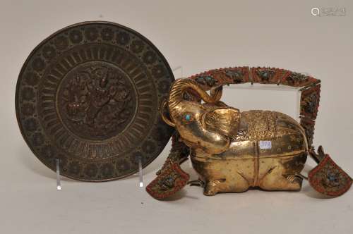 Lot of three metal works. To include: A gilt metal elephant, a repousse saucer dish and a brass necklace inset with Buddha's in blue and coral colored glass.