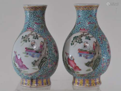 Pair of porcelain vases. China. Early 20th century. Pear shaped with slightly flaring mouths. Reserves of scholars in Famille Rose on a turquoise ground with stylized lotus scrolls. Drilled for lamps. 7