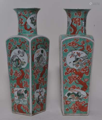 Pair of porcelain vases. China. 19th century. Square baluster form. Famille verte reserves of foo dogs, birds and flowers on a green ground with iron red flowering prunus trees. 18-3/4