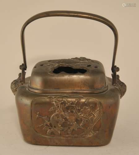 19th century Japanese bronze hand warmer with figural turtle handle supports and cover. Panels with stag and squirrel in a landscape. Hsuan Te mark on bases. 8-1/2